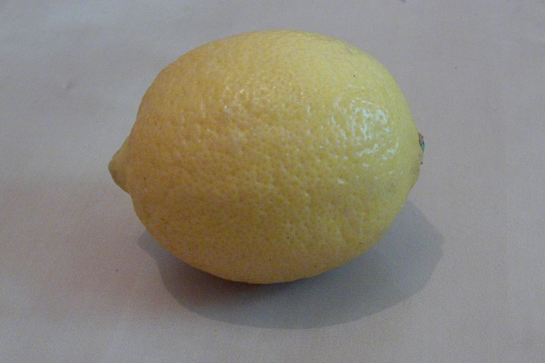 there is a large, ripe lemon on the table