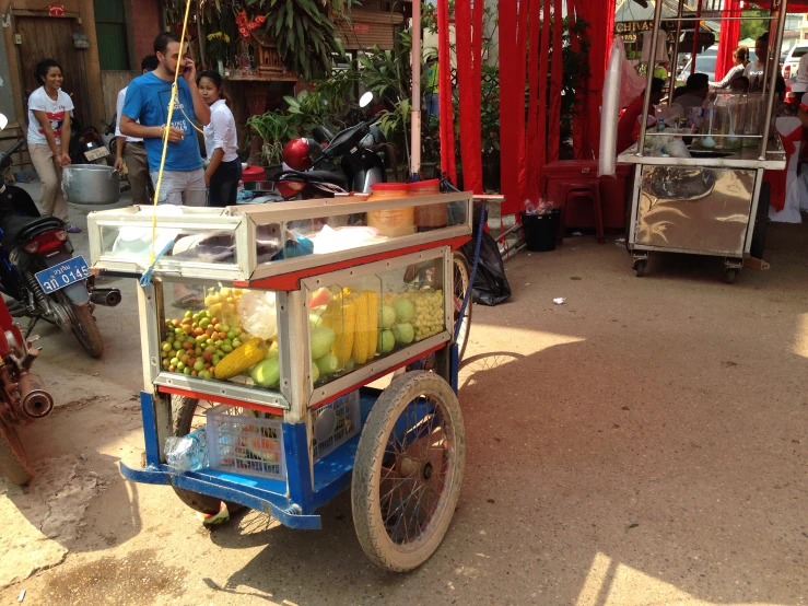 a cart is displaying various fruits and vegetables