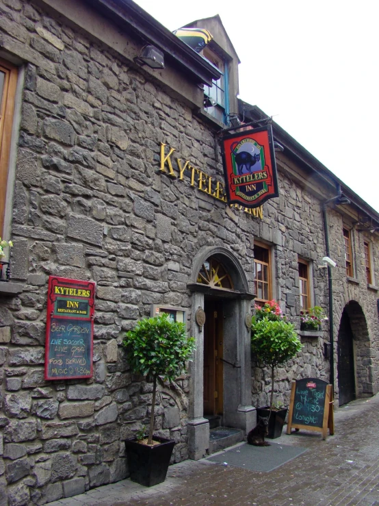 the entrance to a pub with outdoor seating