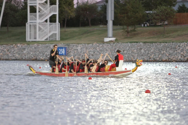 a boat with many people in it on a lake