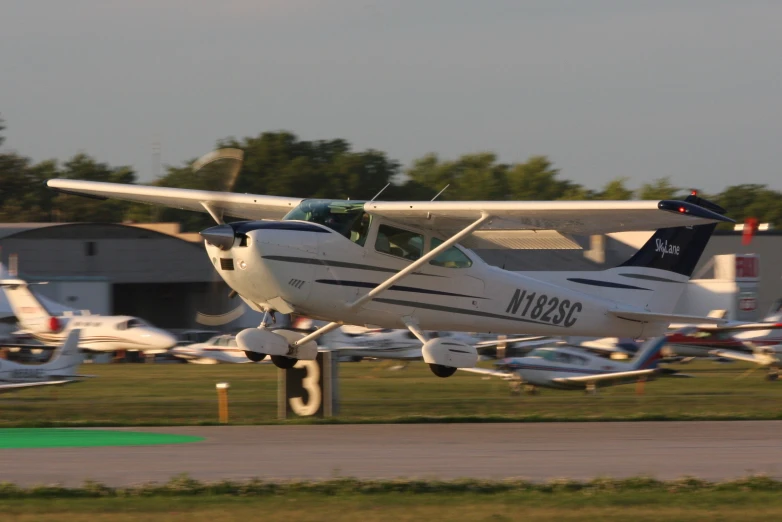 small passenger plane taking off from an airport runway