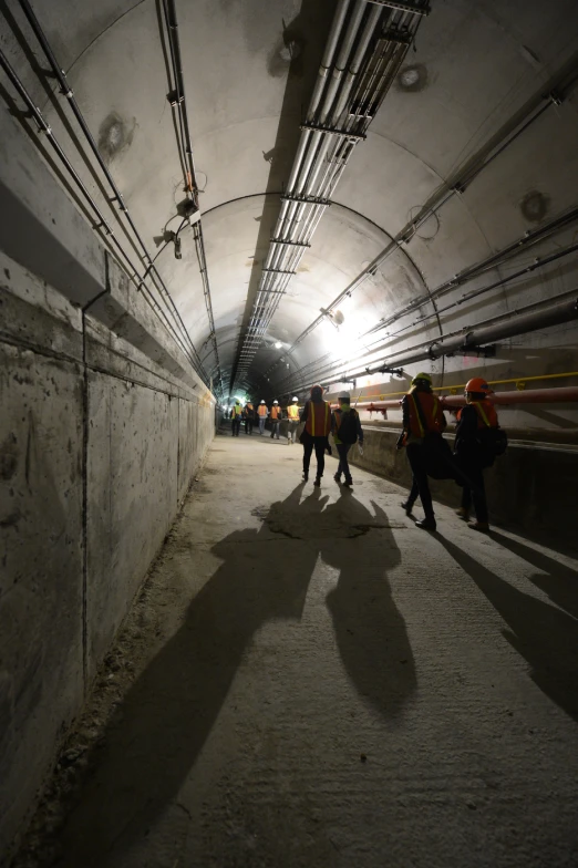 a large subway tunnel full of people with a man walking beside