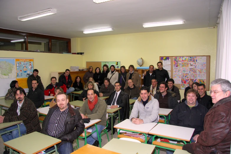 a group of people standing in a classroom