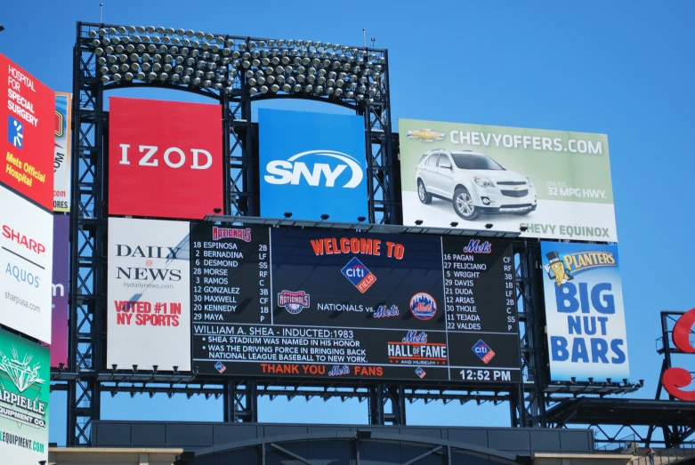 a group of billboards on a city street in front of buildings