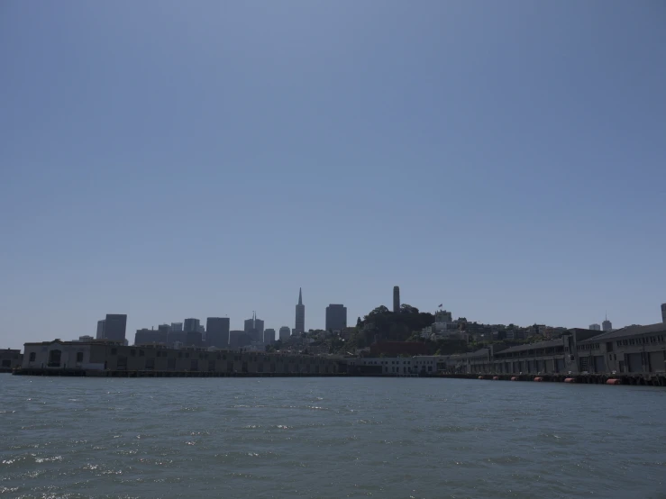 the city skyline is seen from the ocean