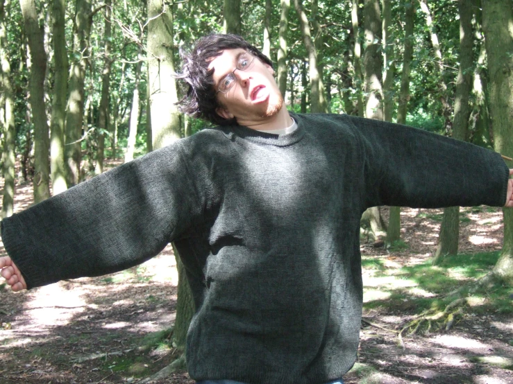 a person in a black shirt and some trees