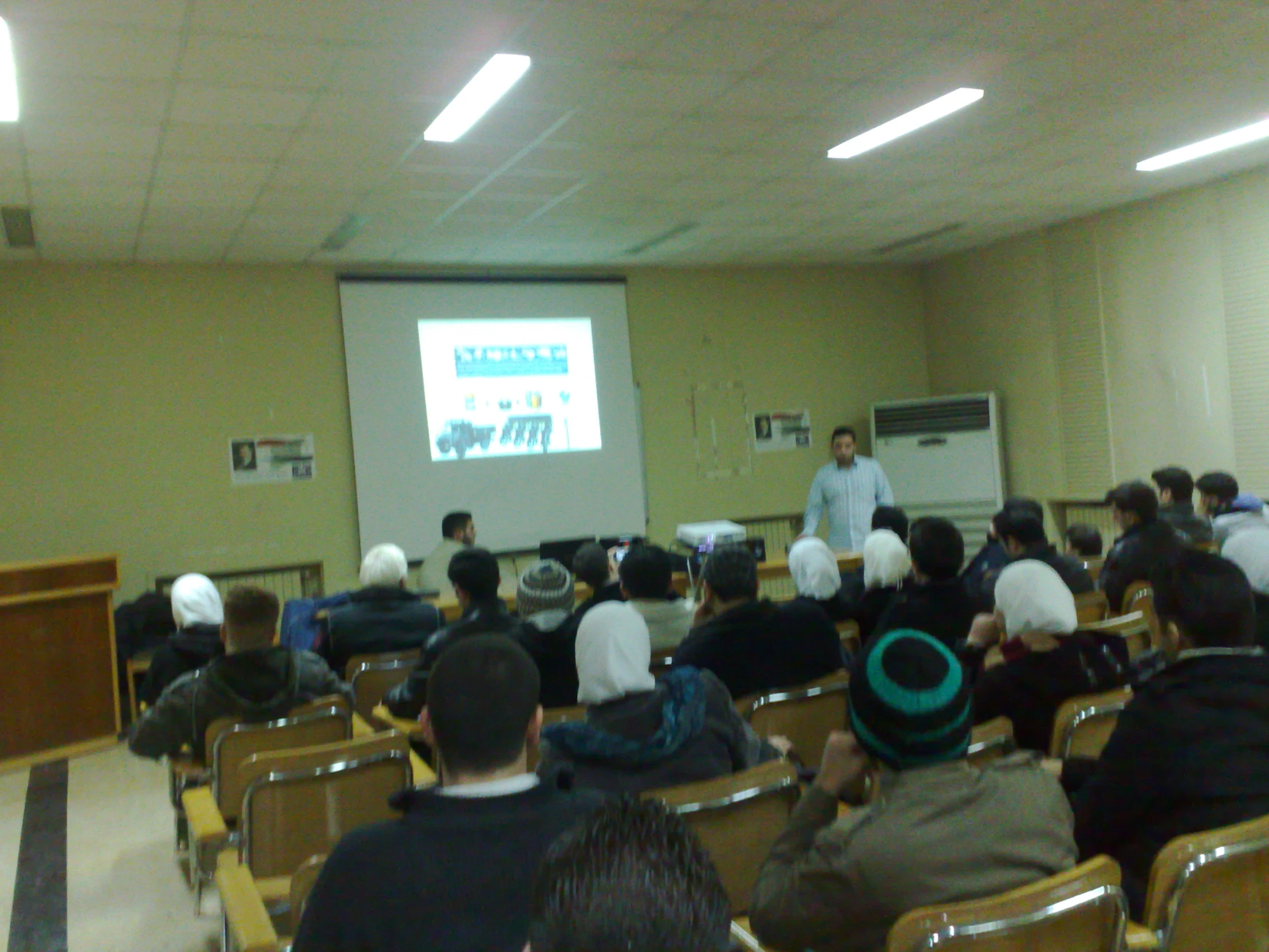 a man standing in front of a classroom filled with people