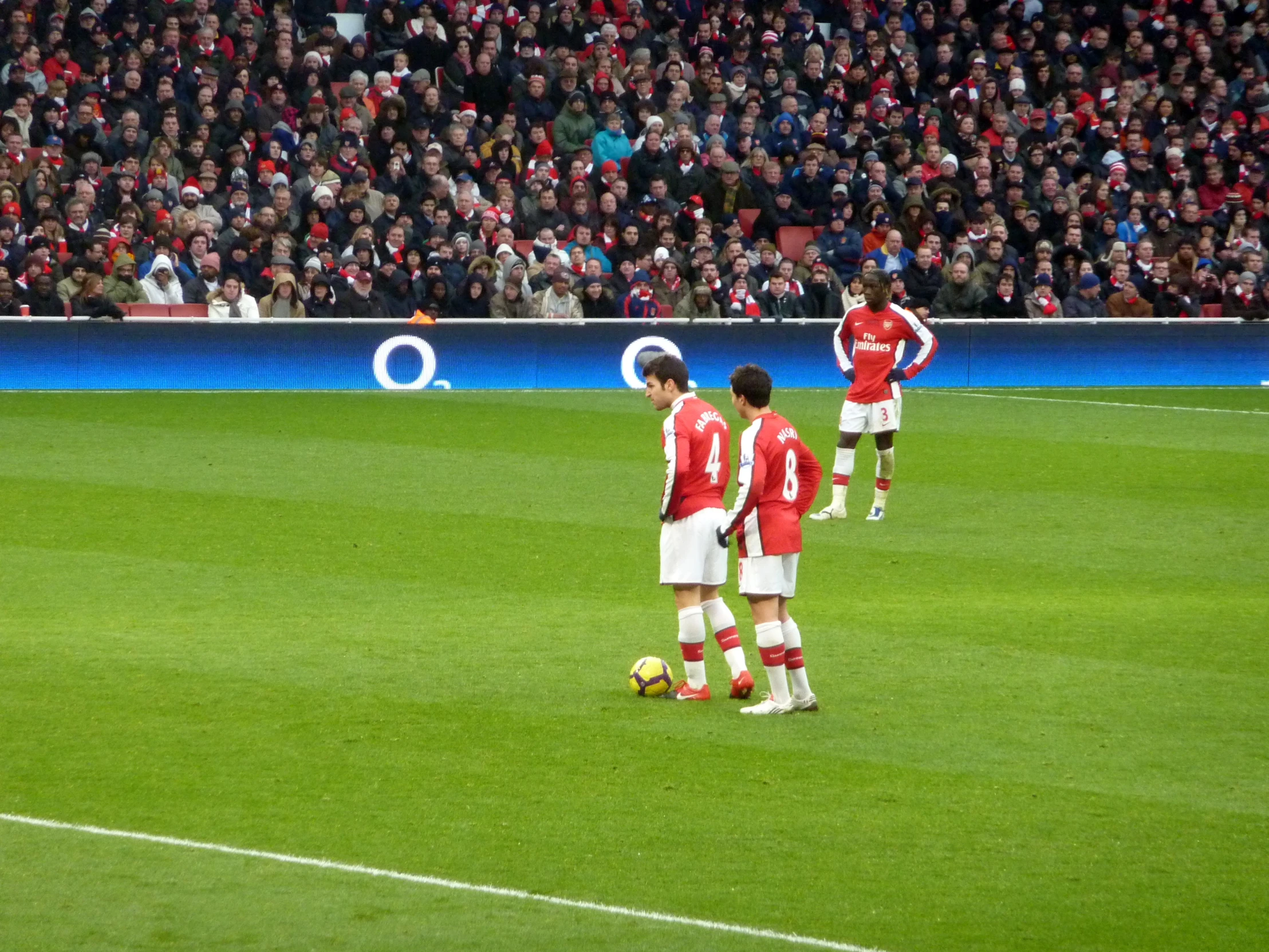 a soccer team playing soccer during a stadium match