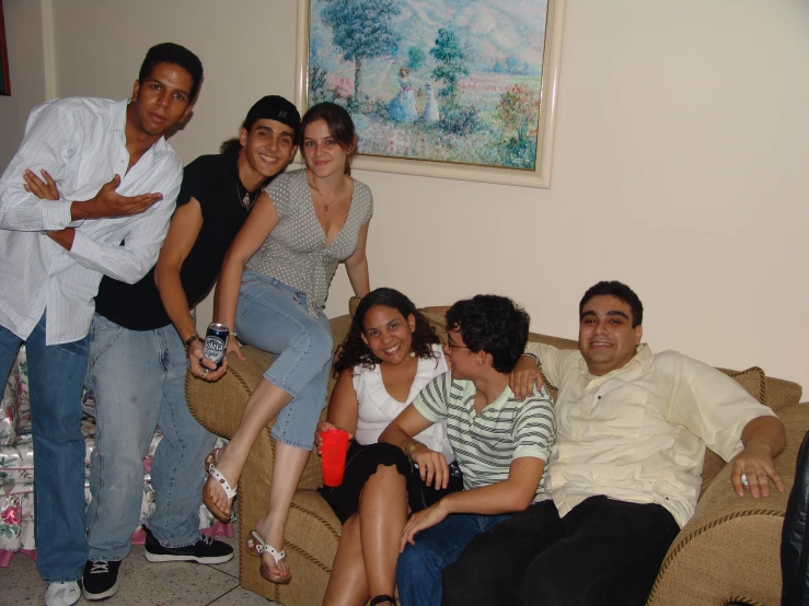 a group of people sitting on a couch next to each other