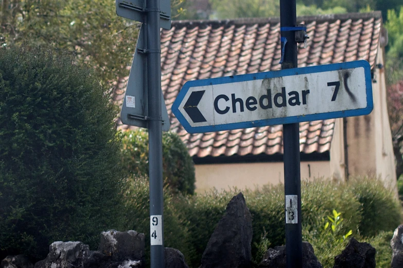 an arrow street sign hangs in front of a building