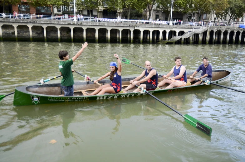 a group of people are riding in a canoe