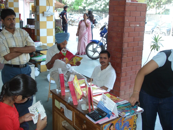 there are many people holding gifts at the table