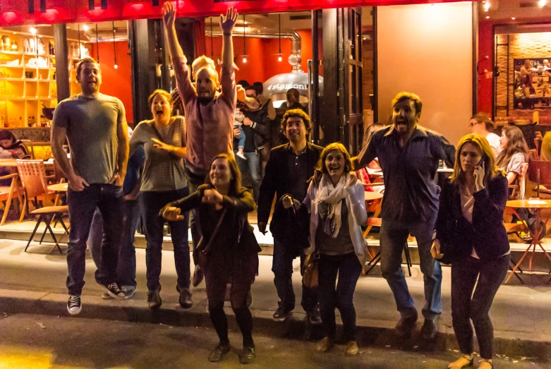 a group of people stand together in front of a restaurant