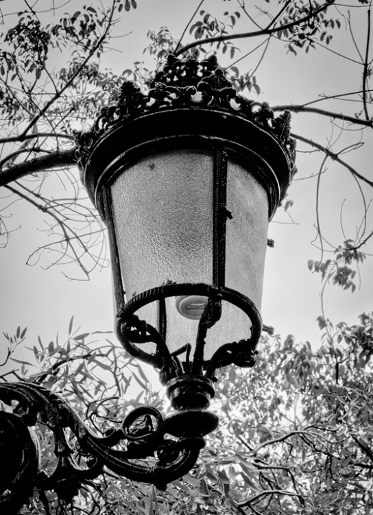 a street light hanging from a metal post