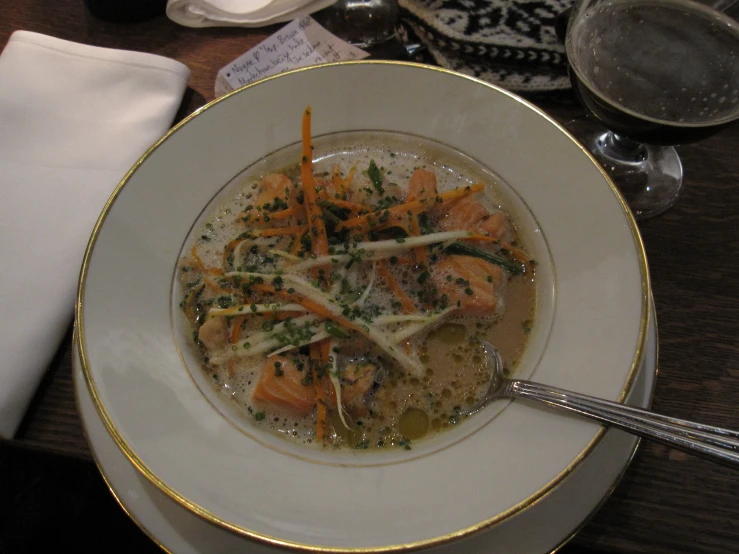 soup in a bowl with broccoli and carrots on top