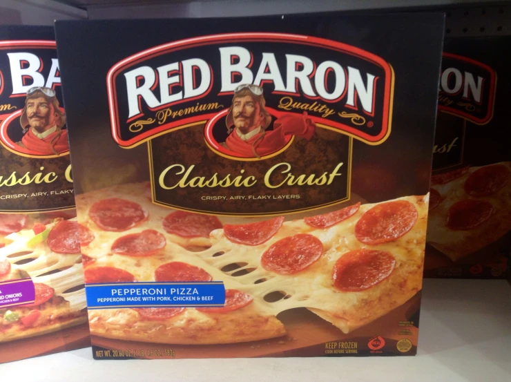 two boxes of red baron's classic crust pizza on a shelf