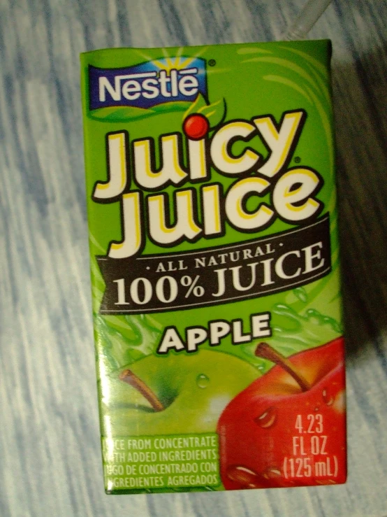 a box of juice sitting on top of a bed