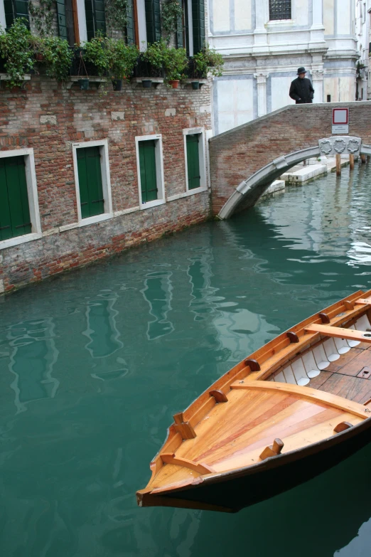 a small boat moored at the side of a canal