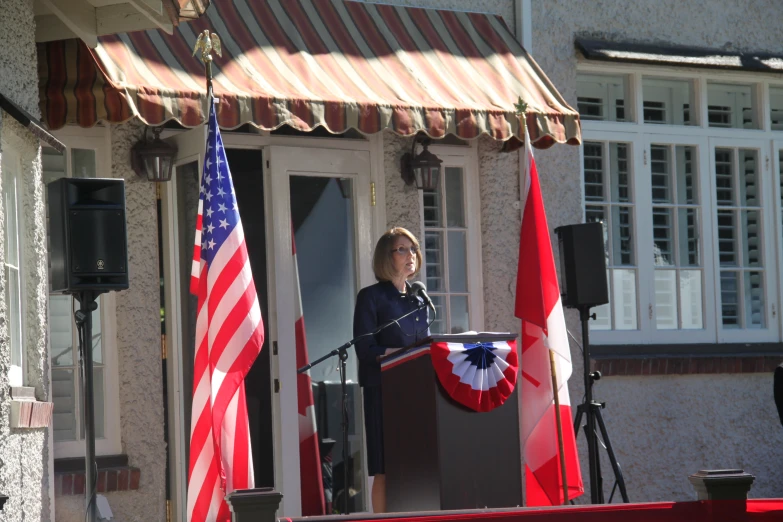 a woman standing in front of a podium while speaking