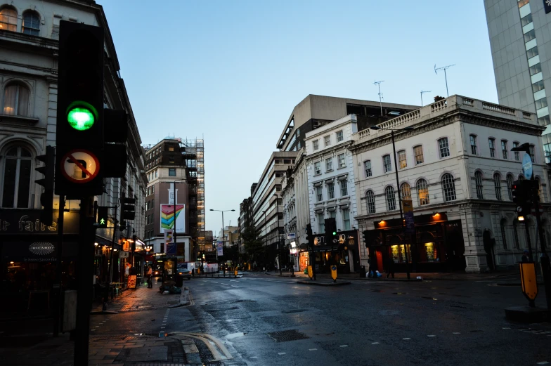 a street with buildings on both sides and a traffic light above