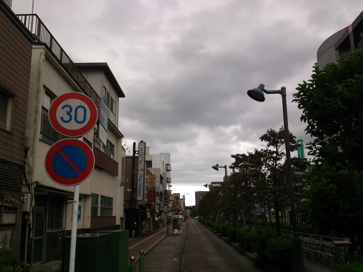 two signs are on the street near the street light