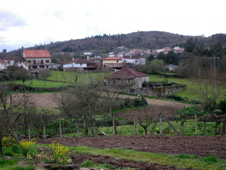 an old farm in the foreground with homes in the background