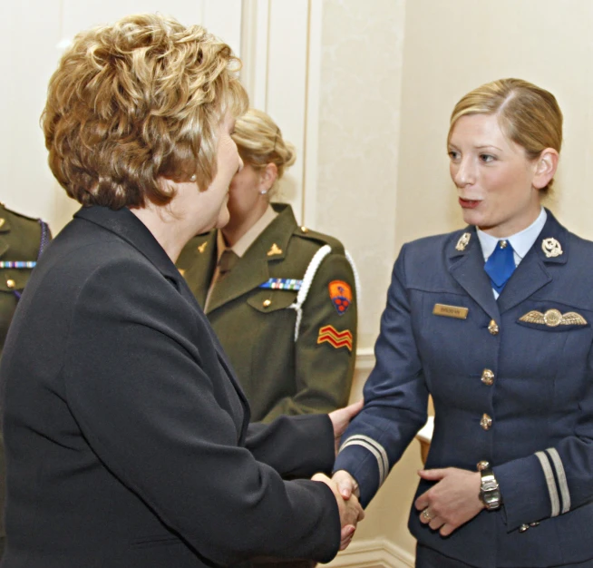 a group of people in uniform talking to each other