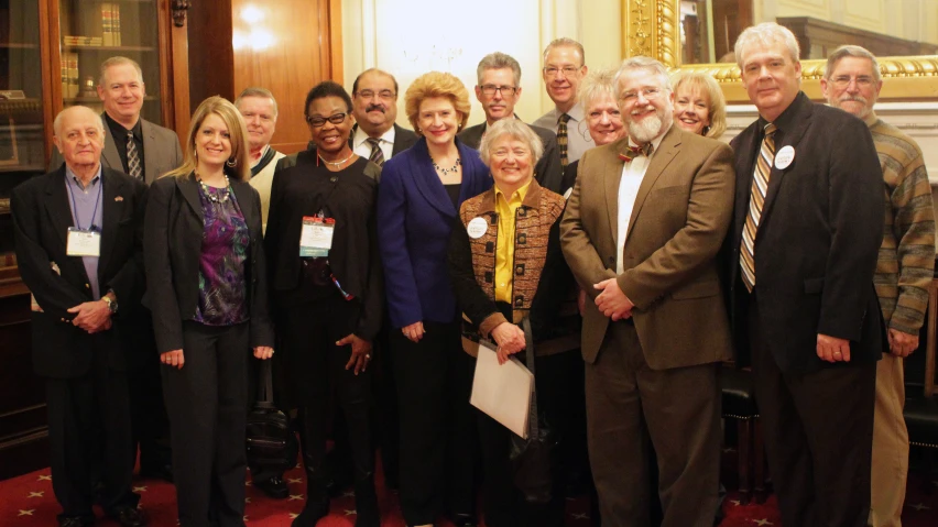 a group of people are smiling in the room