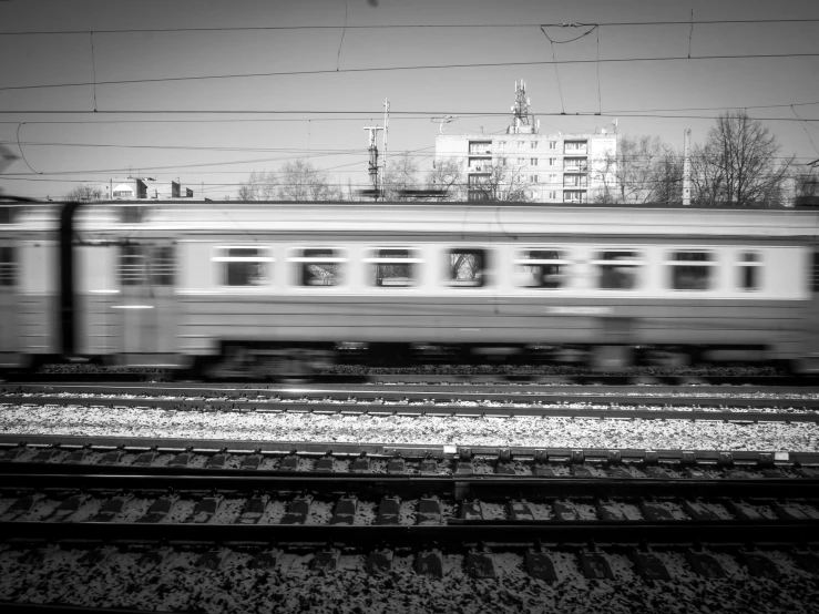 a black and white po of a train going through a city