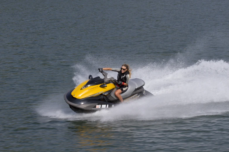 the woman is riding on a jet ski across the water