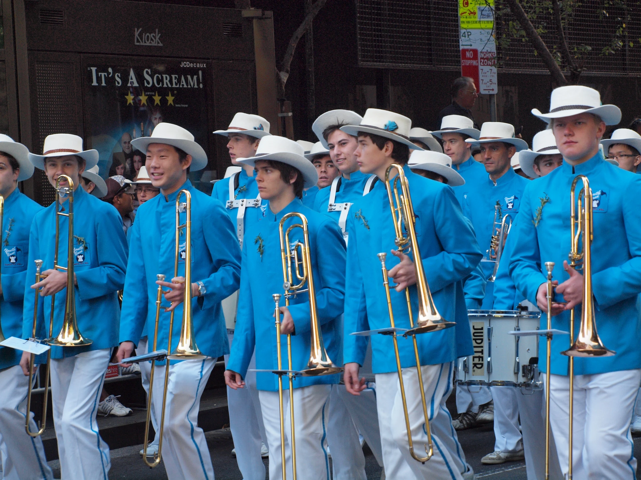 a group of boys playing musical instruments in the street