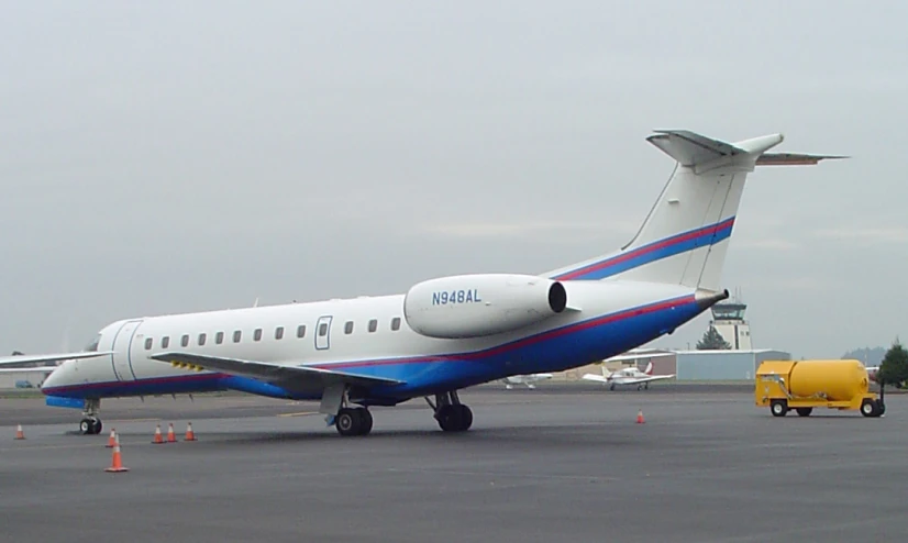 an airplane on the tarmac, with one person getting off