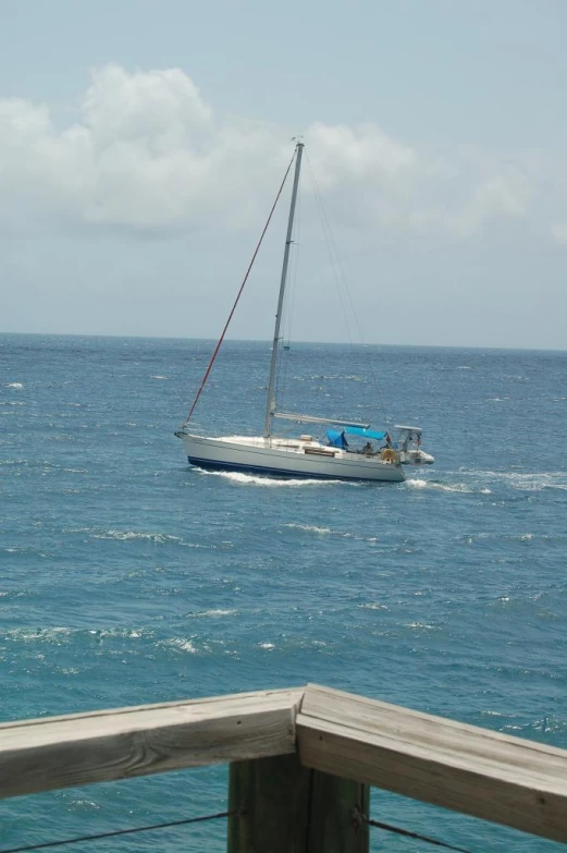 a boat floating in the ocean near a dock