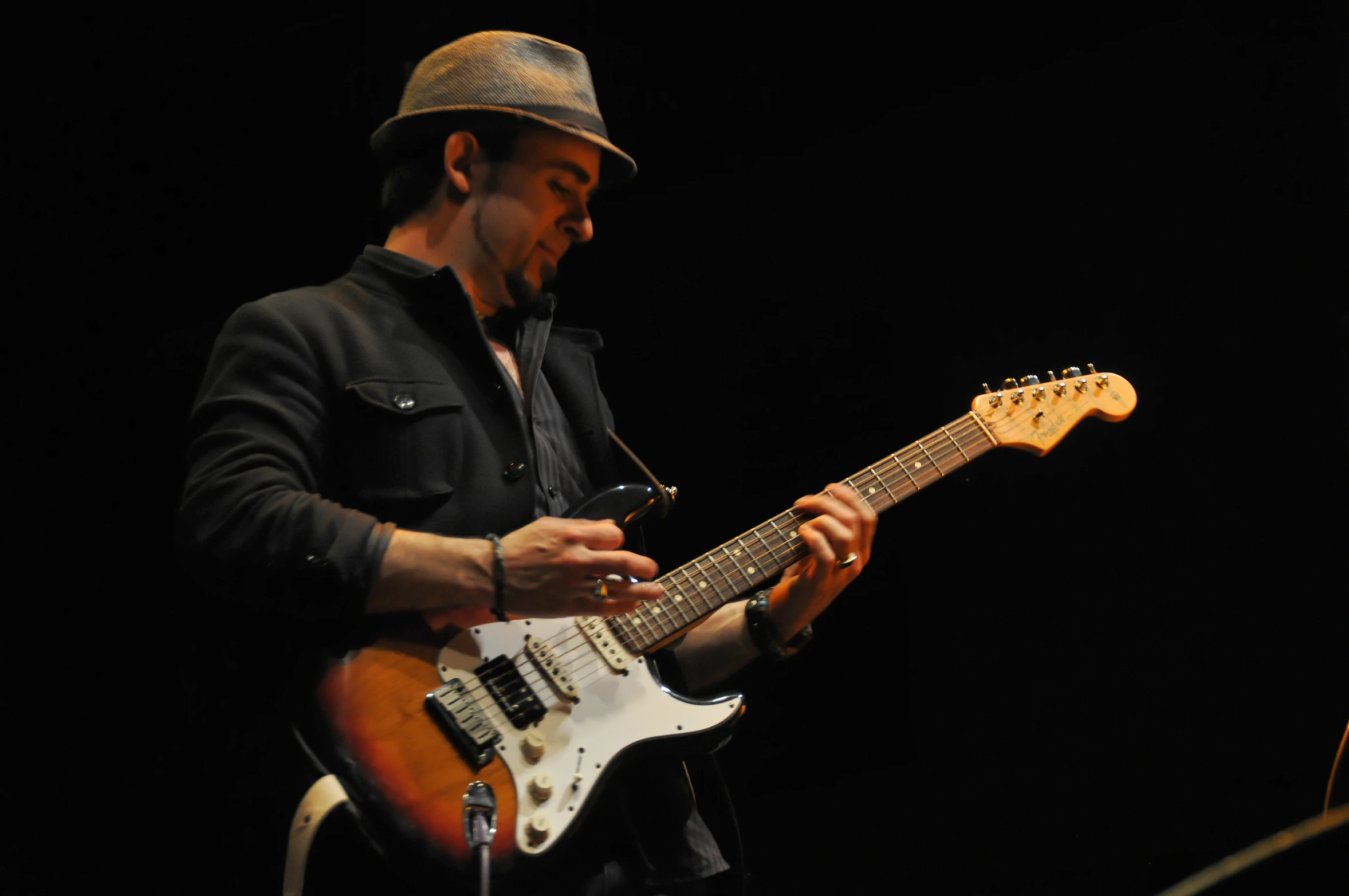 a man is playing an electric guitar on stage