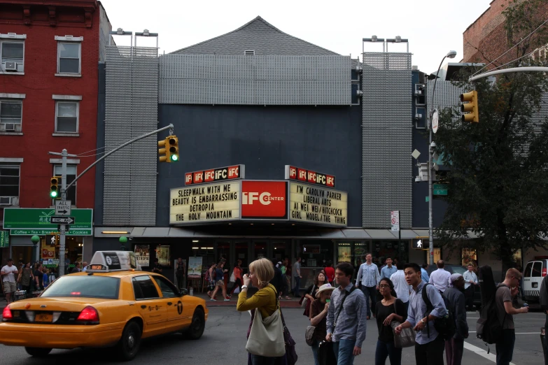 there is a crowd of people gathered at the theater