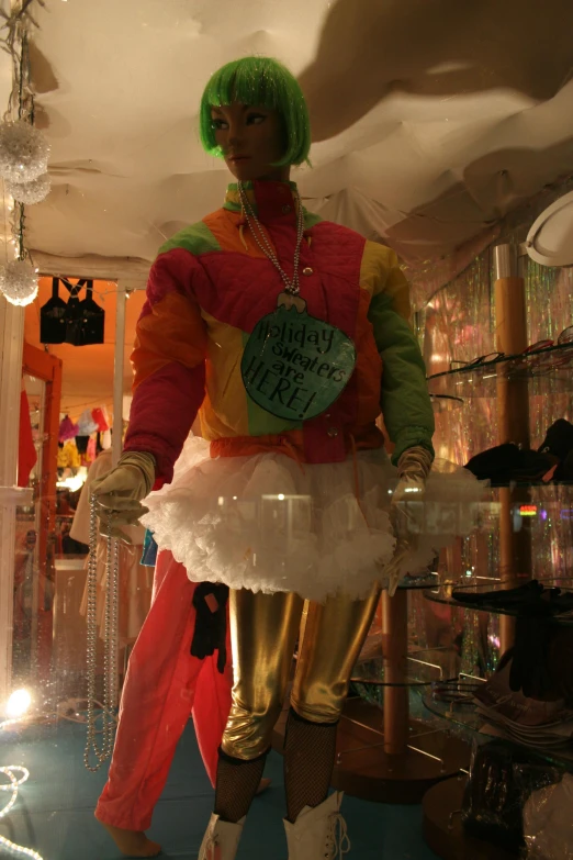 a doll with a green wig is in a display