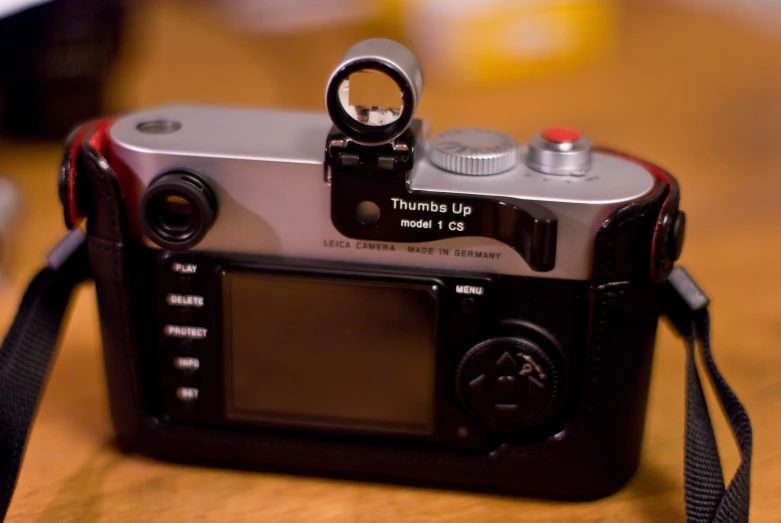 a close up of a camera and a strap