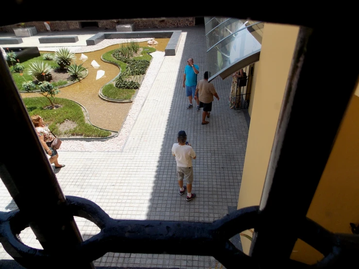 looking down at people on the walkway of an indoor shopping mall