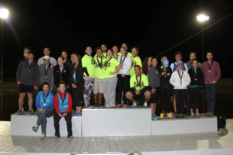 the men and women of a competition with their trophies