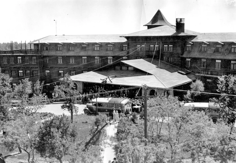 black and white po of an old building surrounded by trees