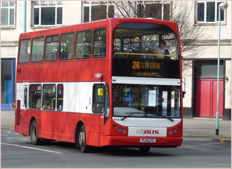 a double decker red bus on the street