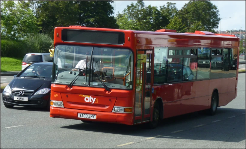 the city bus is traveling down the road