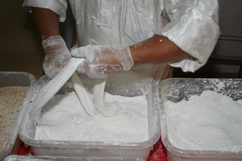a man in gloves is standing in front of some baking ingredients