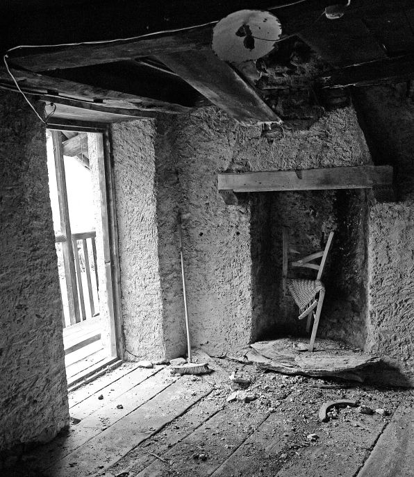 an old run down room with a broken chair