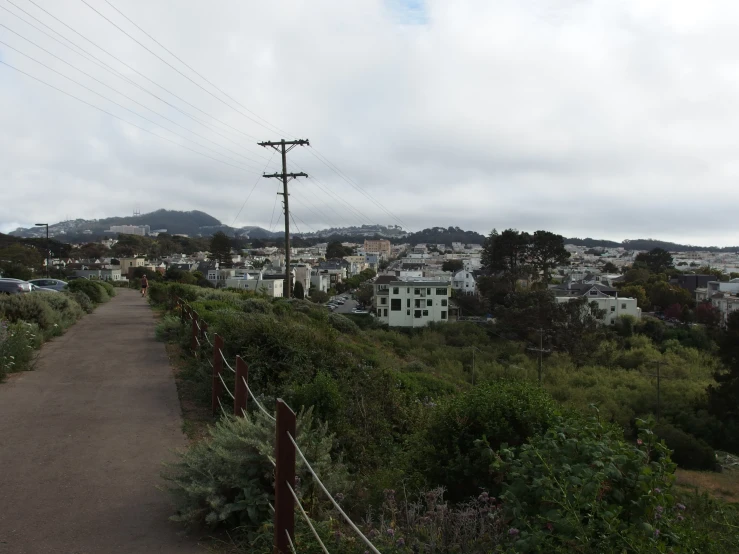 a road and fence in the country side of town