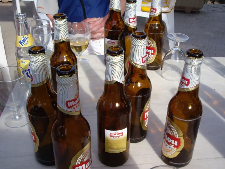 several large brown bottles are lined up on a table
