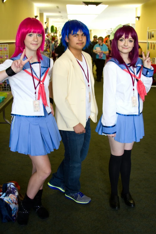 three people with purple hair posing in a school hallway