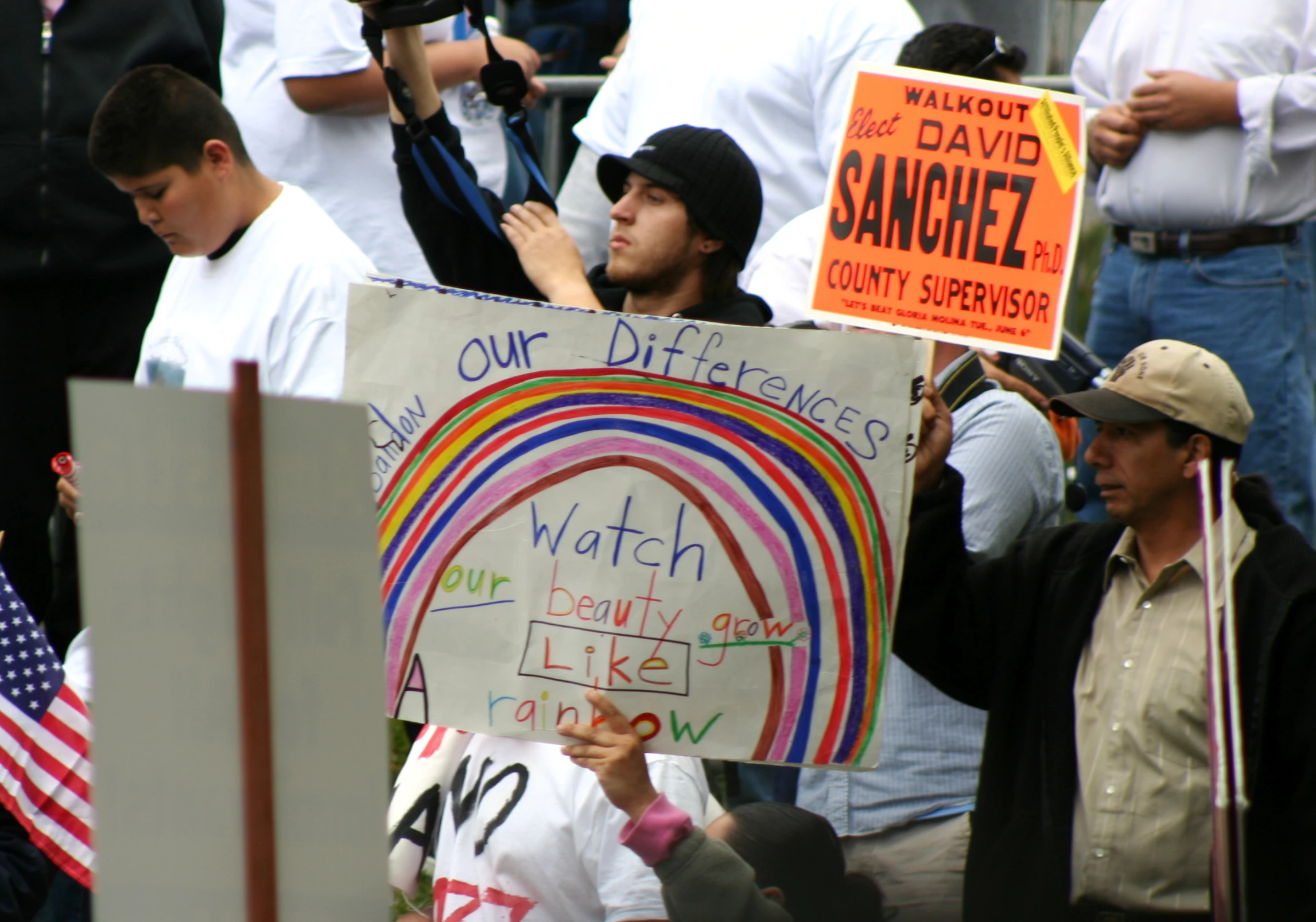 a man holding a sign in the middle of a crowd