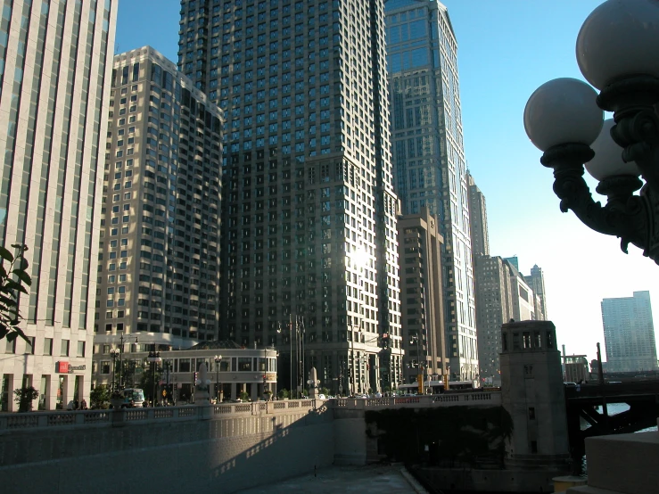 large buildings rise behind a bridge in a city