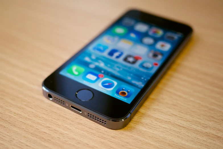 a phone sitting on top of a wooden table